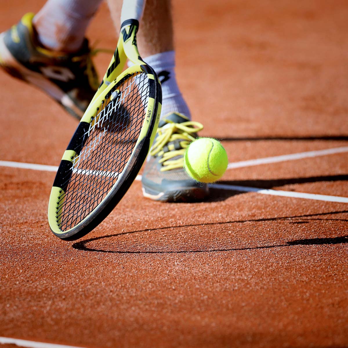 Ein Tennisspieler bereitet sich darauf vor, den Ball mit Schwung zu treffen.